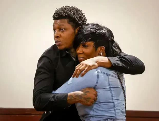 Antonio Nelson (T9ine) embracing a family member in a Hillsborough County courtroom after charges were dropped